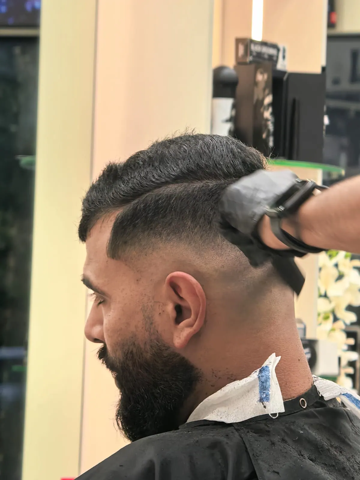 Beard shaping and skin fade in progress at Spazio Gents Salon, JVC Dubai