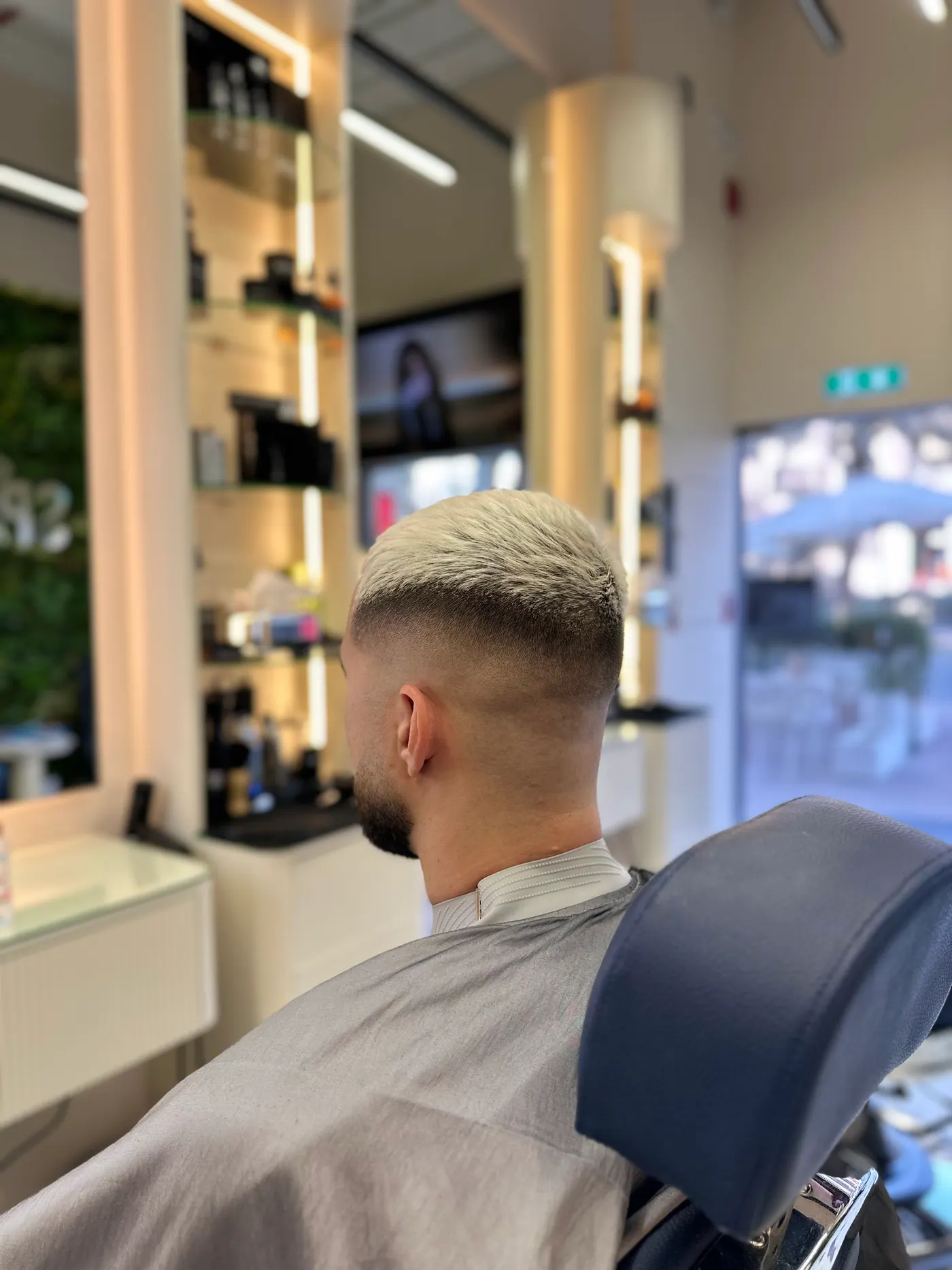 Short blonde buzz cut with a clean fade at Spazio Gents Salon in JVC