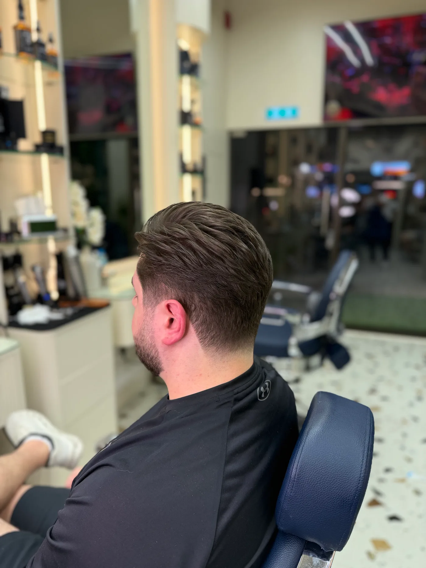Finished slick-back haircut with a tapered side at Spazio Gents Salon JVC