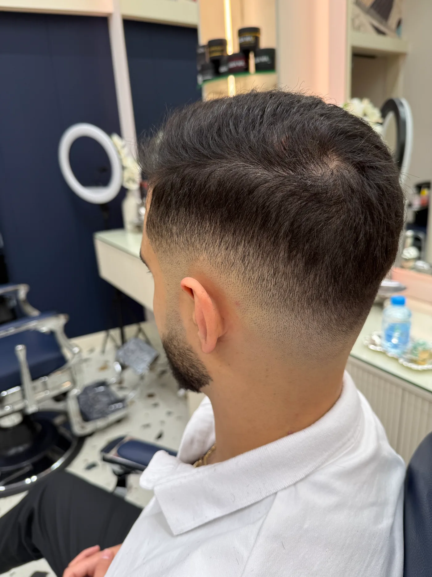 Finished taper haircut with a shaped beard, side view, at Spazio Gents Salon in JVC, Dubai