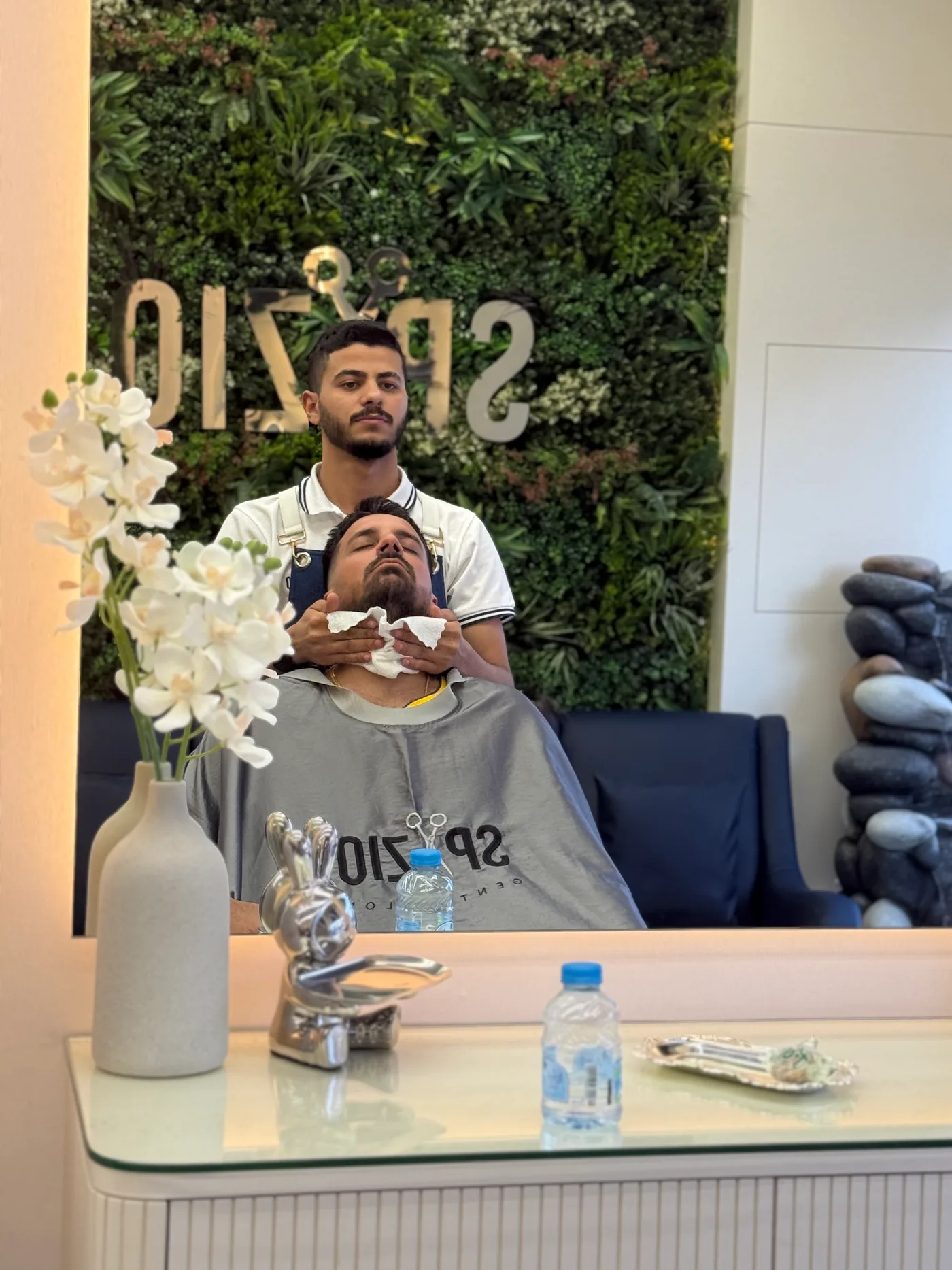 Client relaxing with a hot towel before a shave at Spazio Gents Salon in JVC, Dubai