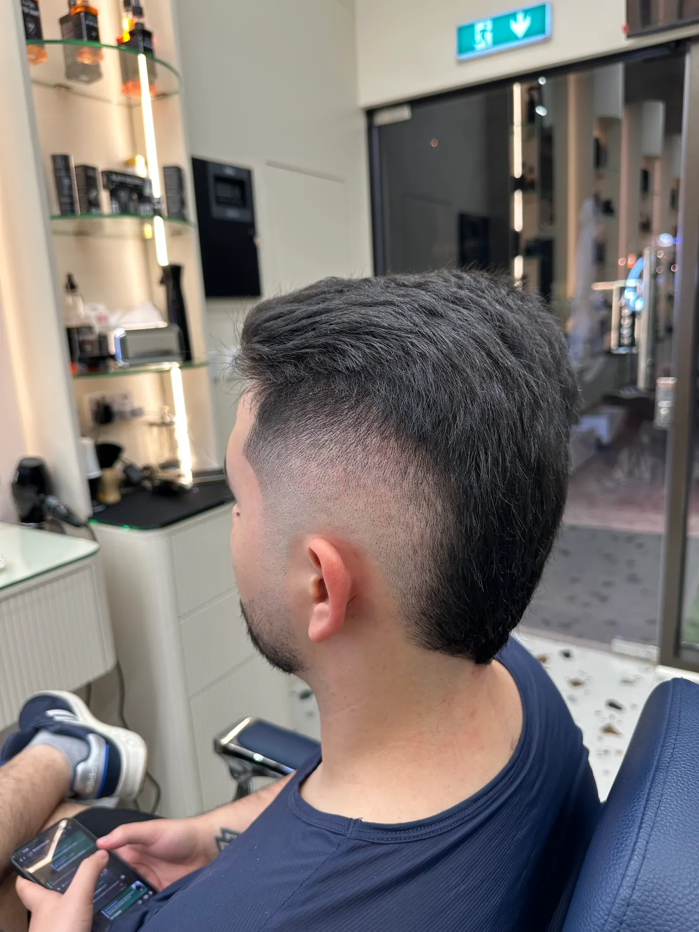 Quiff and skin fade haircut by the window at Spazio Gents Salon in JVC