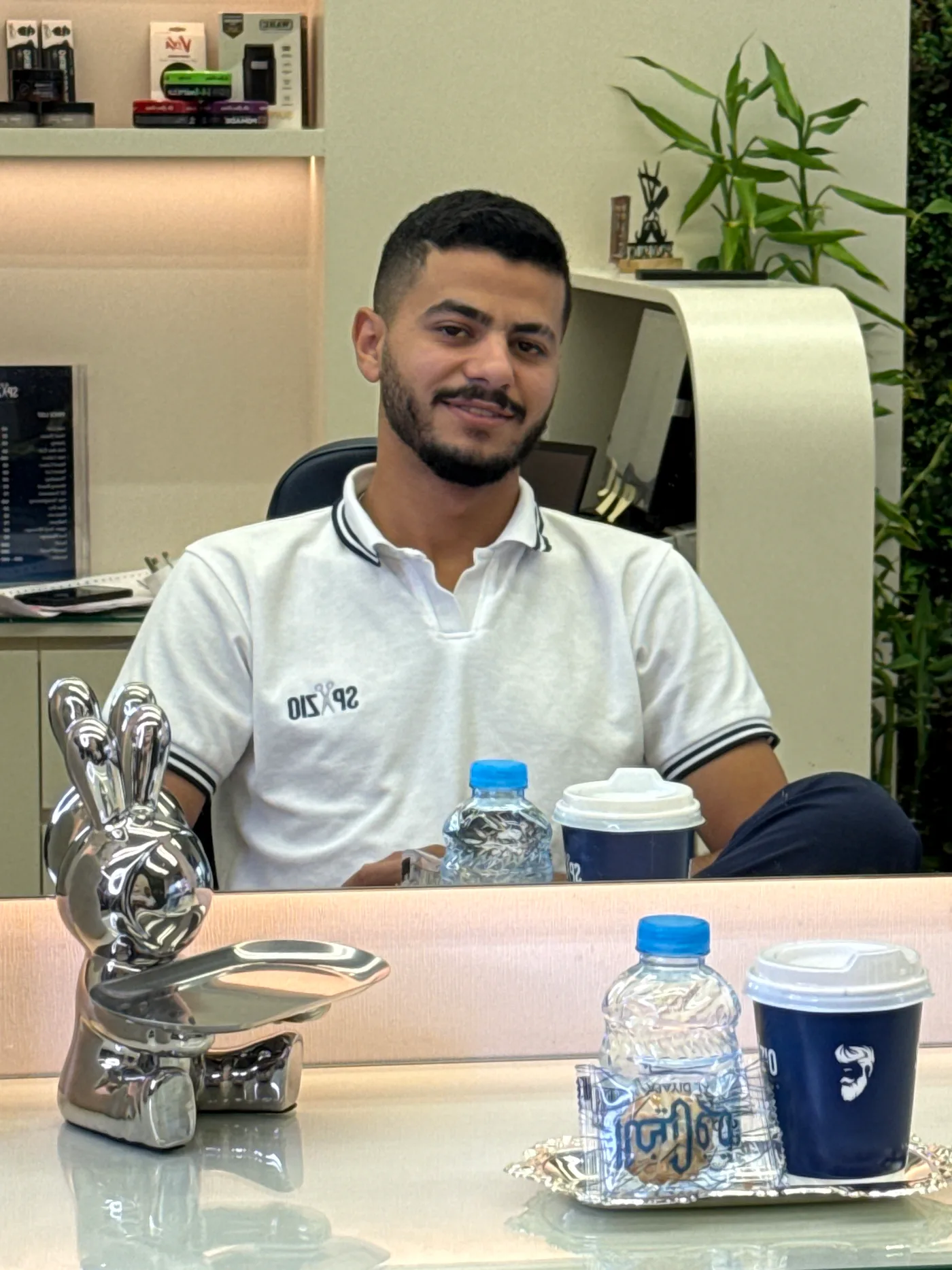 Reception at Spazio Gents Salon in JVC, Dubai, with coffee and water ready for waiting clients