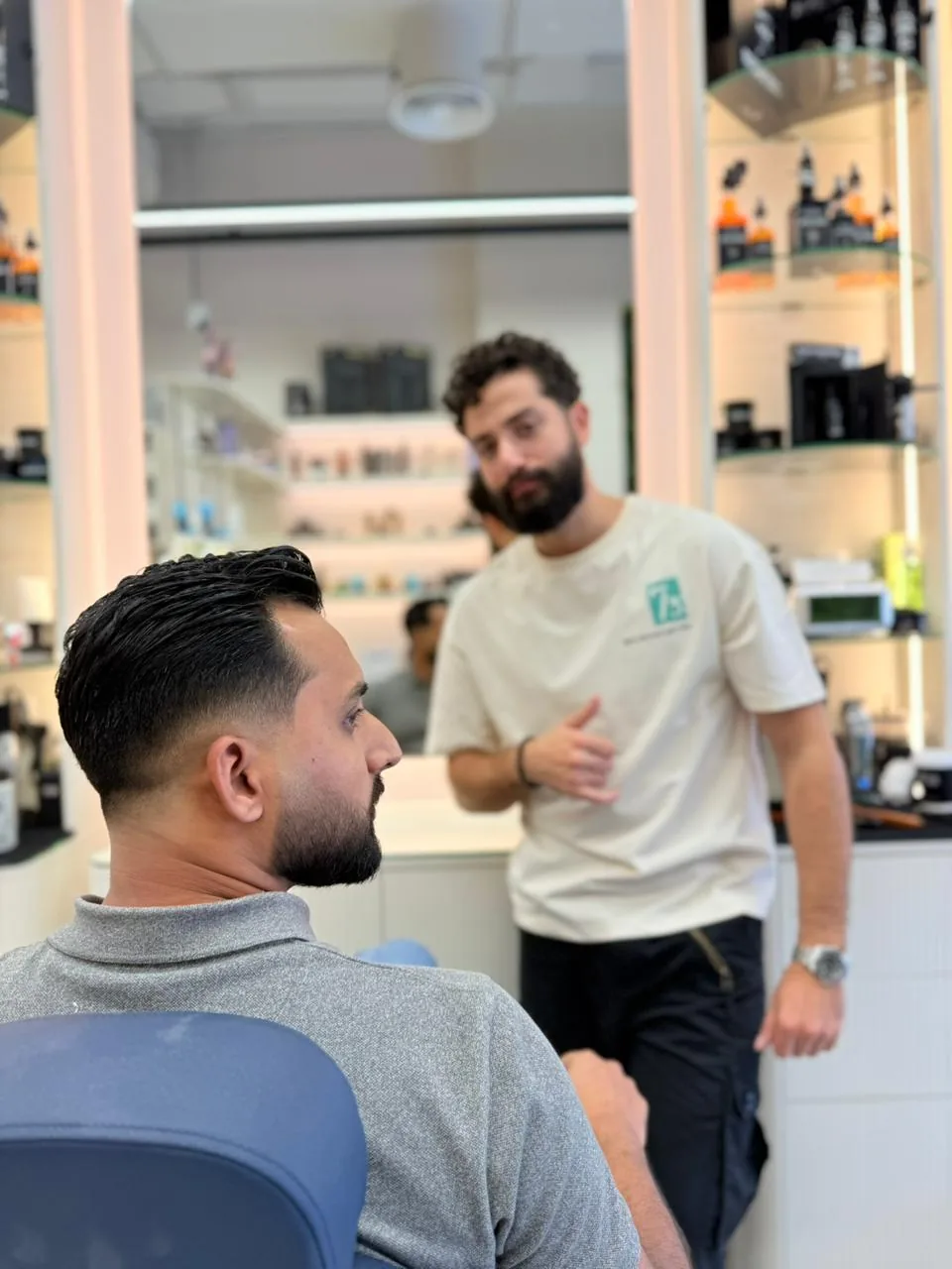 The barber chairs and salon floor at Spazio Gents Salon in JVC, Dubai