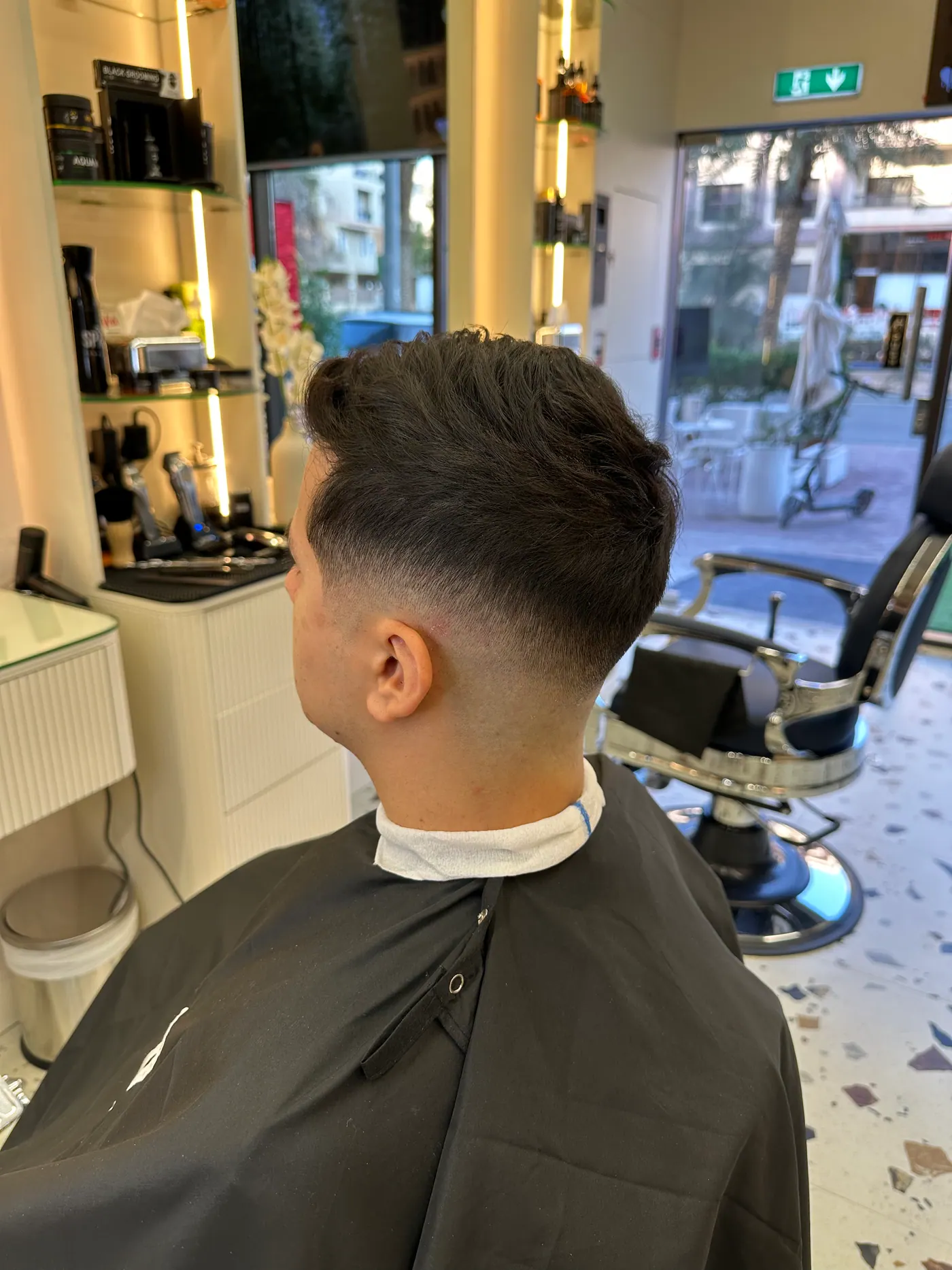 Back view of a textured crop haircut at Spazio Gents Salon, Jumeirah Village Circle