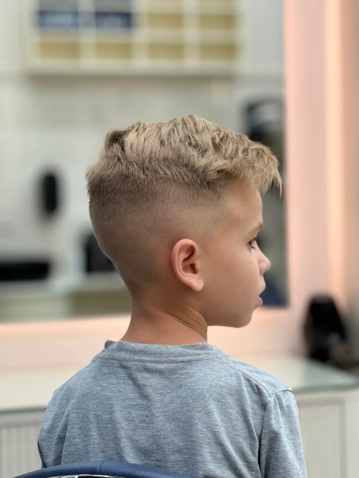 Boy’s high skin fade with a textured top, finished kids haircut at Spazio Gents Salon in JVC, Dubai