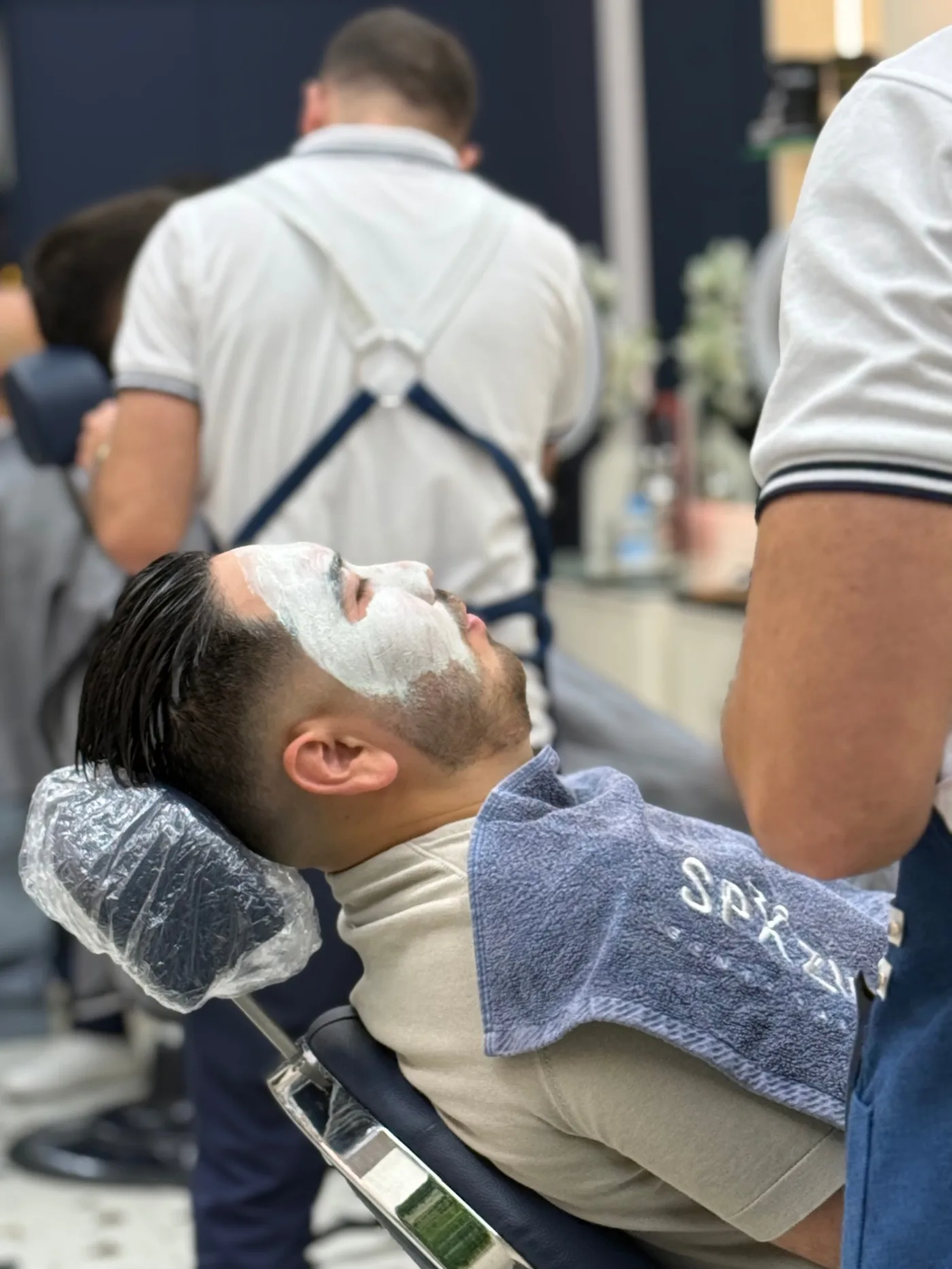 Men's facial treatment with a clay mask applied at Spazio Gents Salon in JVC, Dubai