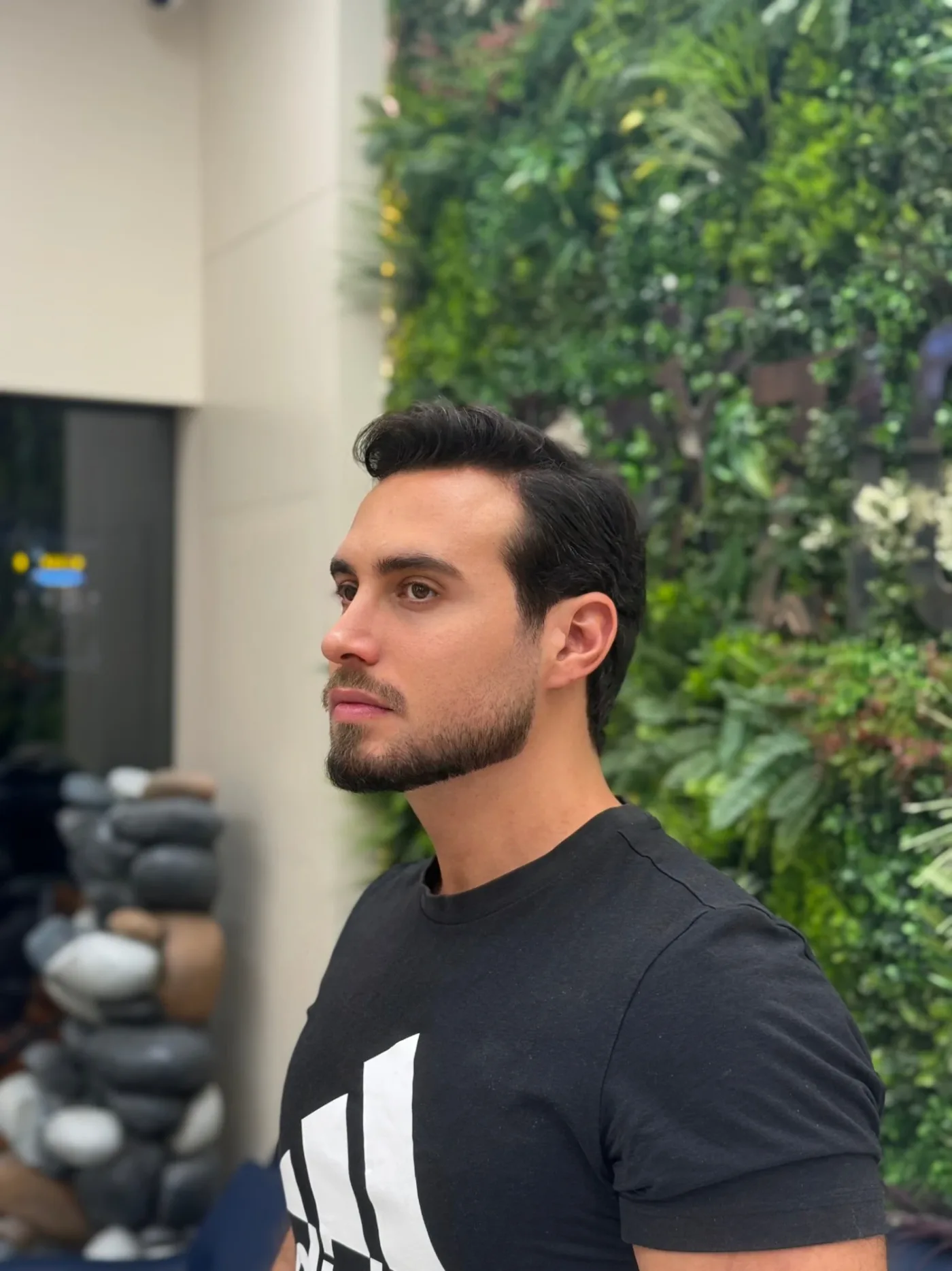 Textured quiff haircut with a shaped beard, finished at the green wall at Spazio Gents Salon in JVC, Dubai